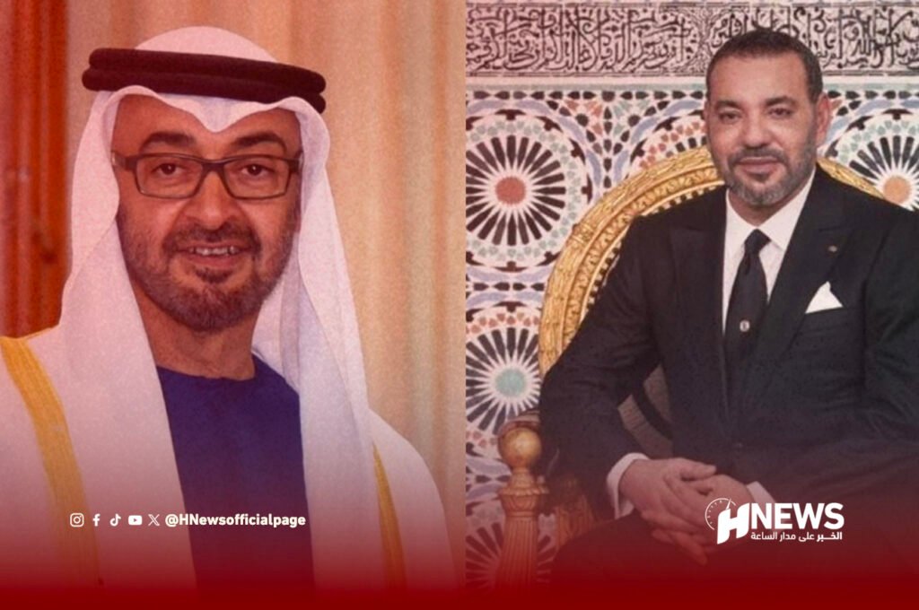 Two men posing for a formal photo: left in traditional Arab dress with glasses, right in a black suit, ornate backdrop; HNEWS watermark.