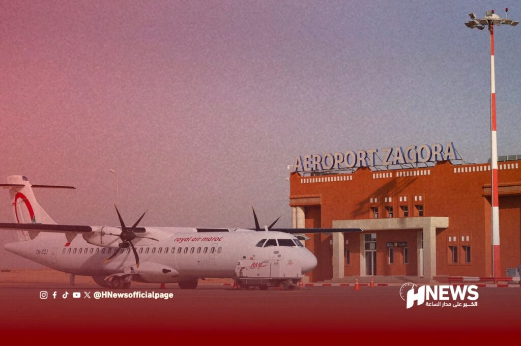 مطار زاكورة | H-NEWS آش نيوز Airplane on tarmac in front of Zagora Airport terminal with red-brick building and H News watermark on the bottom right.