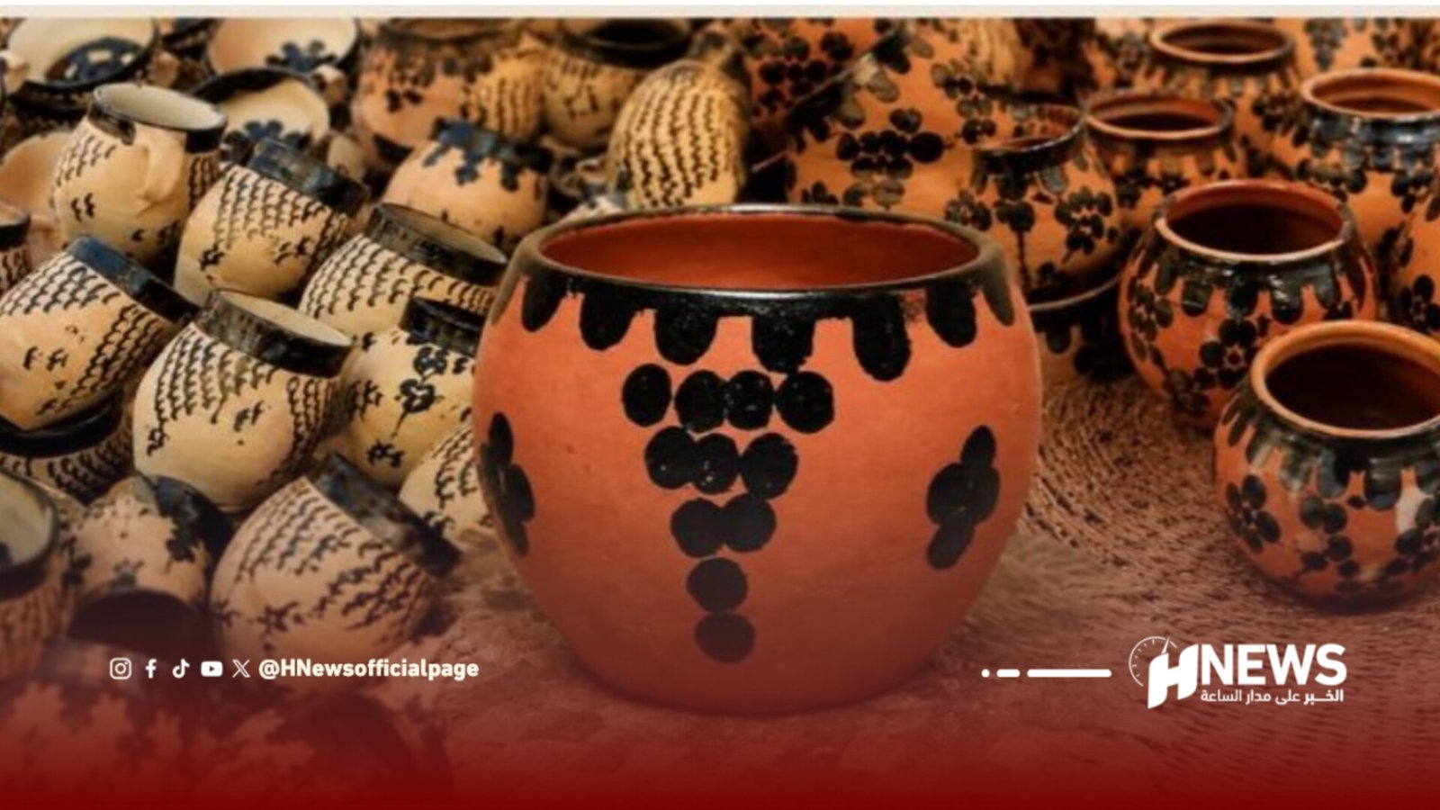 Cluster of traditional terracotta pots with black geometric designs.