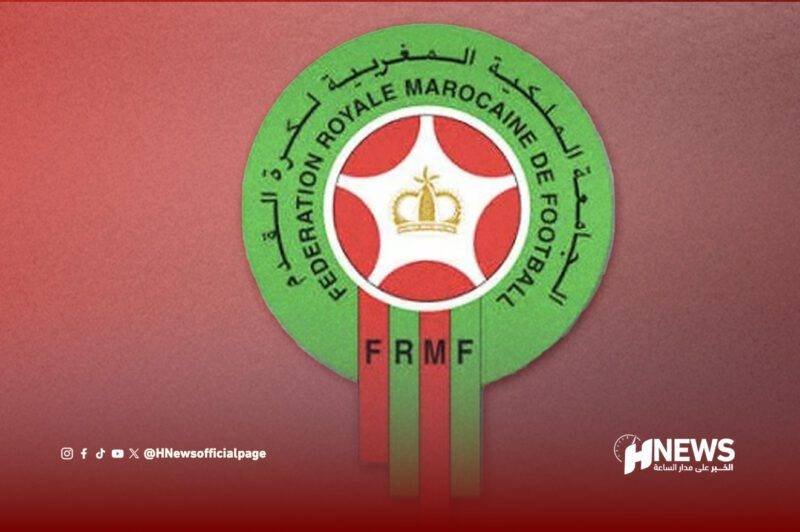 Circular FRMF badge: green ring with Arabic text, crown emblem center, red-green ribbons reading FRMF (Fédération Royale Marocaine de Football)