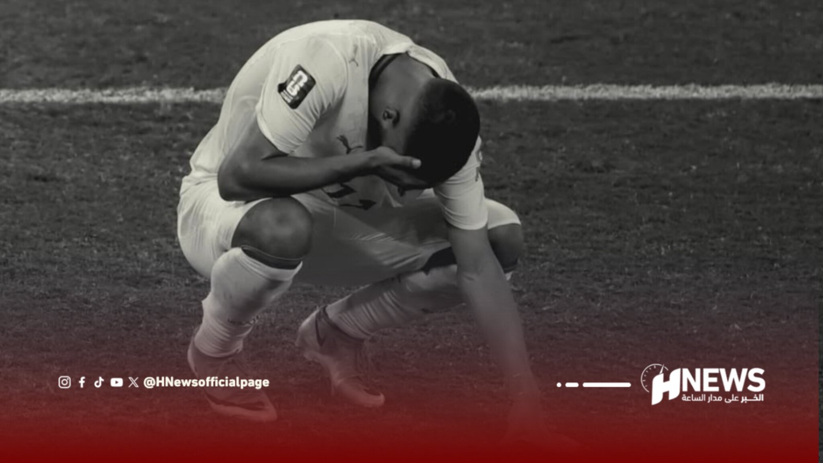 Two soccer players in white kits struggle for the ball on a grass field during a match.
