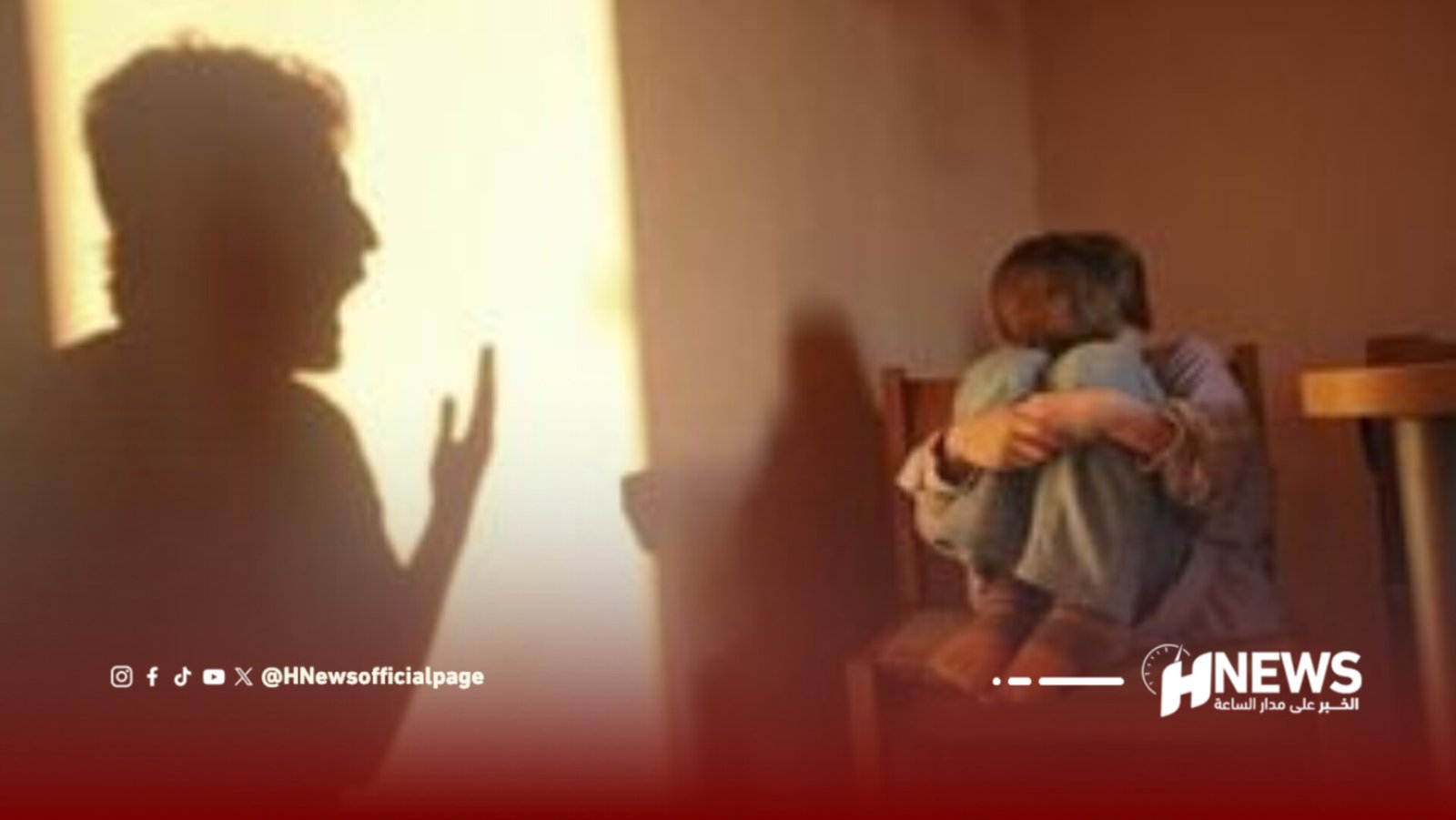 A shadowy figure on the left gestures toward a person sitting on a bed in a dim room lit by warm light from a doorway or window.
