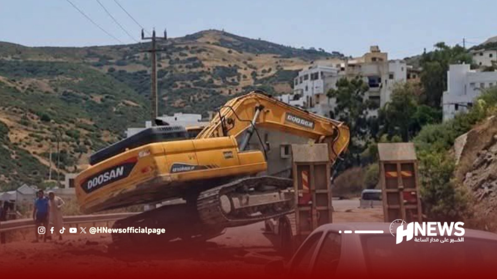 Yellow Doosan excavator loading dirt onto a truck in a hillside town.