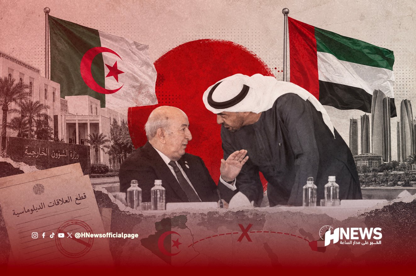 Two men in a formal discussion lean toward each other at a table, with Algerian and UAE flags in the background, suggesting a diplomatic meeting.